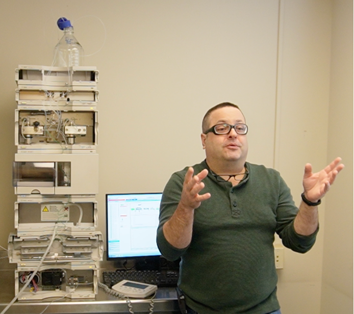 Certified HPLC technician from Cribworks Analytical performing maintenance on laboratory equipment